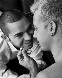 Photo of homosexual couple holding engagement ring